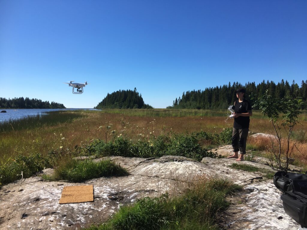 Photo showing a drone pilot flying a drone.